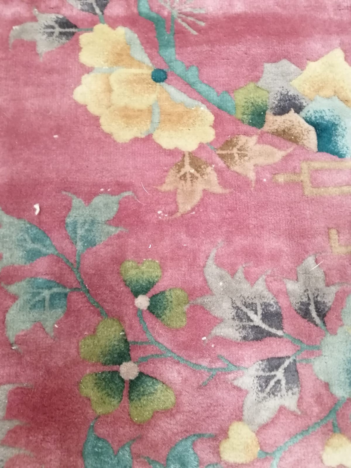 A large early 20th century Chinese cerise ground floral ground carpet, 530 x 358cm